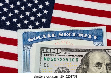 Social security card, 100 dollar bill and American flag. Concept of social security benefits payment, retirement and federal government benefits - Shutterstock ID 2045231759