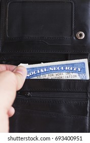 Social Security Card In Simple Black Wallet, Slightly Sticking Out. 