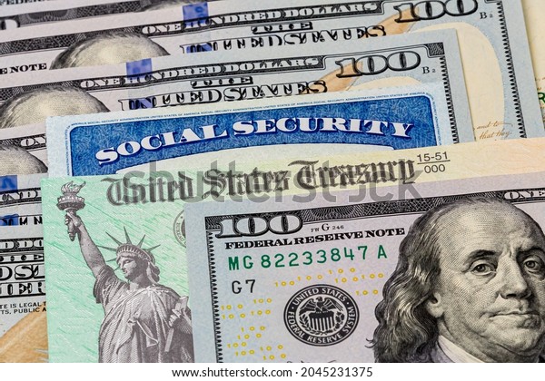 Social Security card, treasury check and 100
dollar bills. Concept of social security benefits payment,
retirement and federal government
benefits