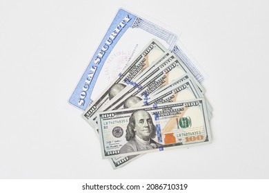 Social Security Card And Us Dollars Cash Money On White. Social Security Benefits. Concept Of Social Security Benefits Payment, Retirement And Federal Government Benefits