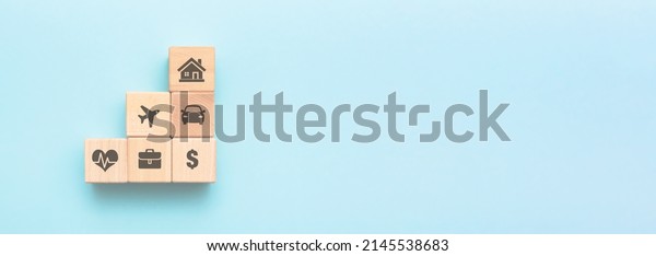 Social security concept. Wooden blocks with\
insurance symbols, copy\
space