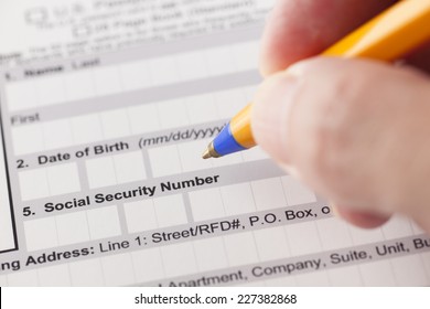 Social Security Number Fields In Application Form And Human Hand With Ballpoint Pen.