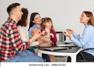 Social Worker Meeting With Couple For Signing Adoption Documents