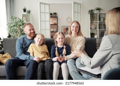 Social Worker Talking To Adoptive Family At Home