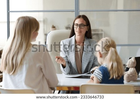 Social worker talking to single mom in office
