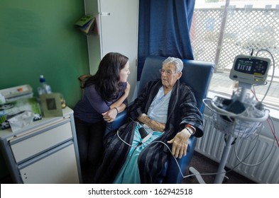 Social Worker Visit Sick Old Male Patient In Hospital.Real People. Copy Space