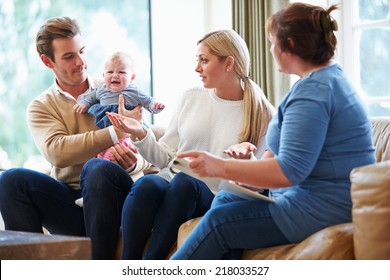 Social Worker Visiting Family With Young Baby