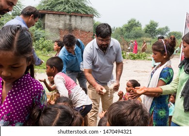 Social Workers Distributing Food To The Kids Of Slum Area : Noida, Uttar Pradesh/India - August 2019