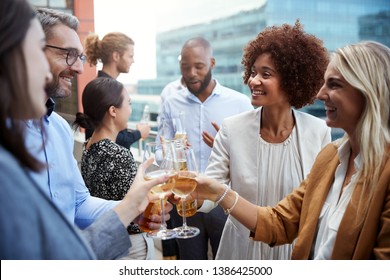 Socialising Office Colleagues Raising Glasses And Making A Toast With Drinks After Work