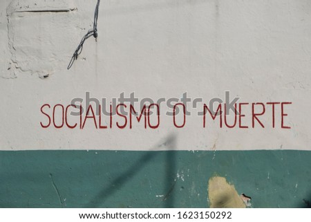 Socialism or death (socialismo o muerte) sign in Spanish on painted wall in the center of old Havana. Space for copy.