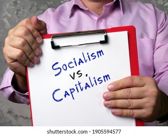  Socialism Vs. Capitalism Sign On The Piece Of Paper.
