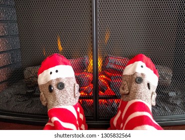 Sock Monkey Footy Pajamas In Front Of Fireplace At Christmas