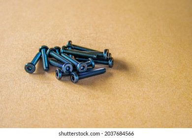 Socket button head of black  on brown background.