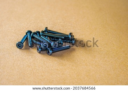 Socket button head of black  on brown background.