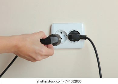 Socket with electric plug in the wall. Copy space. The concept of energy savings.