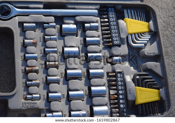 Socket set\
with wrenches and sockets in a\
container