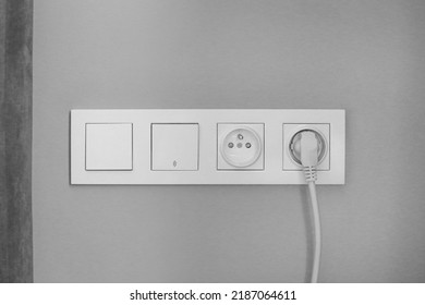 sockets next to the bed, 2 switches and 2 sockets, electrical planning, convenient, euro sockets. Power sockets on grey wall, closeup. Electrical supply