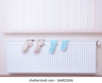 Socks Drying On Heating Radiator