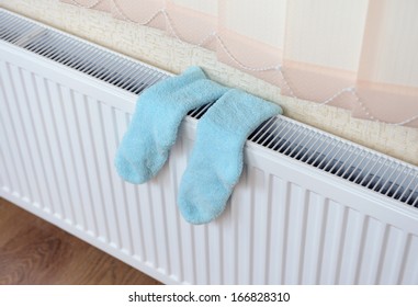 Socks Drying On Heating Radiator