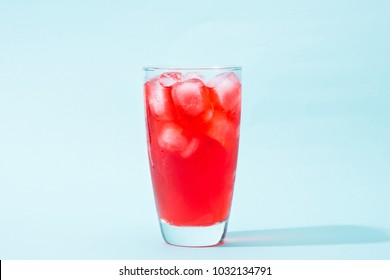 Soda. Red Sparkling Water With Ice In A Glass