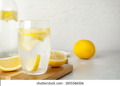 Soda Water With Lemon Slices On Light Table. Space For Text