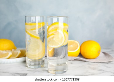 Soda Water With Lemon Slices On White Marble Table