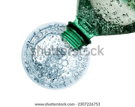Soda water pouring, top view on white background