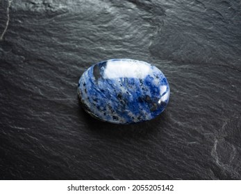 Sodalite Mineral Stone On Slate Worktop. Flat Lay, Top View.