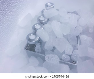 Sodertalje-Sweden - January 2021: Closeup Of Glass Vials With Crimp Caps Placed On Dry Ice Prepared For Medical Transport. The Vials Are Obscured By A Haze Of Sublimating Dry Ice. Selected Focus.