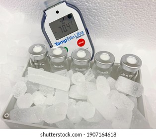 Sodertalje-Sweden - January 2021: Glass Vials With Crimp Locks, With Hoarfrost, On Dry Ice At Very Low Temperature Of Minus 70 Celsius Degrees In A Container For Medical Transportation. Selected Focus