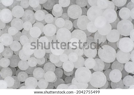 Sodium Hydroxide beads or lye - closeup detail to white granules, image width 19mm