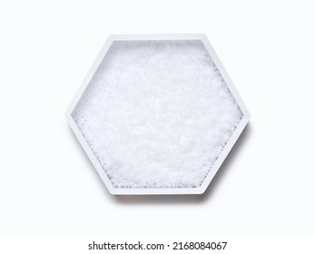 Sodium Hydroxide Pellets in hexagonal molecular shaped container on white background. Top View