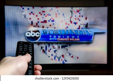 Soest, Germany - January 13, 2019: Man Watching ABC World News Tonight With David Muir On TV.