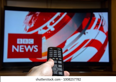 Soest, Germany - January 14, 2018: Man watching BBC News on TV. BBC News is an operational business division of the British Broadcasting Corporation (BBC).