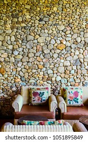 Sofa with a brick wall.