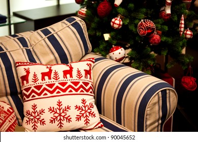 Sofa Decorated For Christmas With Red And White Pillow.