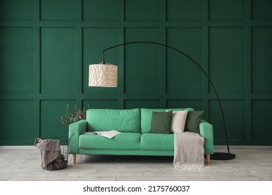 Sofa, Lamp And Table Near Green Wall In Living Room