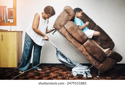 Sofa, lift and cleaning woman with vacuum, strong and comedy with superwoman and housework job. Child, maid and working in a home with cleaner, comic and impossible task in a lounge with kid - Powered by Shutterstock