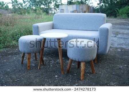 Sofa Setup 2 seater with round table and round stool outdoor backgorund, grey sofa
