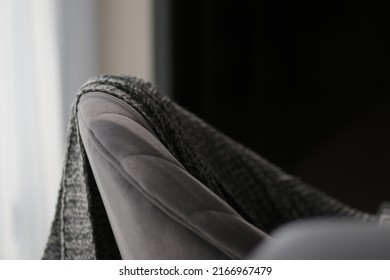 Sofa with velvet texture and gray knitted blanket in modern bedroom. Close up white curtain and wall background for apartment, real estate, living, interior, decoration, house design website. Urban