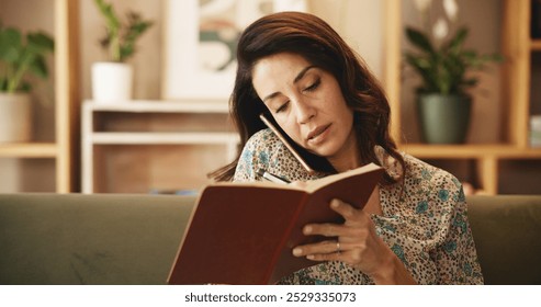 Sofa, woman and phone call with notebook for writing, information and schedule date with client. Freelancer, female person and event planner with mobile for listening, networking and reminder at home - Powered by Shutterstock