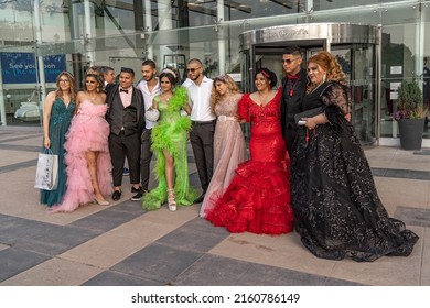 Sofia, Bulgaria - 24.05.2022, A Group Of Students In Fancy Dresses Are Posing Near The Entrance Of A Restaurant At Graduate Prom