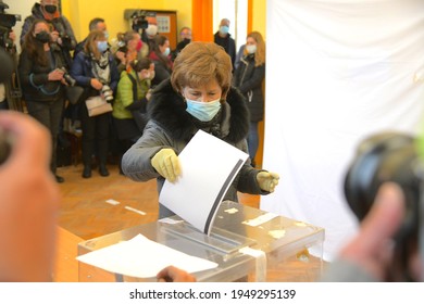 Sofia, Bulgaria - Apr 4 2021: A Woman In Protective Mask And Gloves Is Putting Her Vote Into The Voting Urn