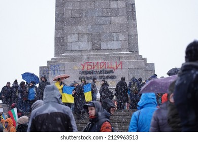Sofia, Bulgaria - February 27, 2022: People protesting in front of the Soviet Army monument in Sofia against Russia's military aggression against Ukraine wrote "murderers" in red