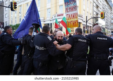 Sofia, Bulgaria - May 09, 2022: Proponents of Ukraine break through police cordon trying to stop them from continuing their march on an unregulated route to the Soviet Army monument