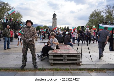 Sofia, Bulgaria - May 09, 2022: Supporters of Russia celebrate Victory Day near the monument to the Soviet army, guarded by a member of a paramilitary organization