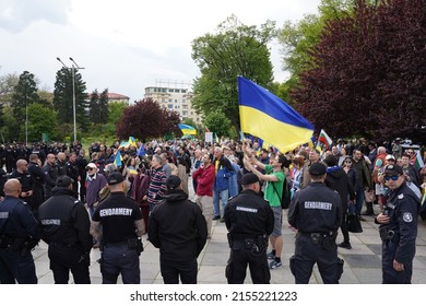 Sofia, Bulgaria - May 09, 2022: Proponents of Ukraine guarded by police cordon trying to stop them from continuing their march on an unregulated route to the Soviet Army monument