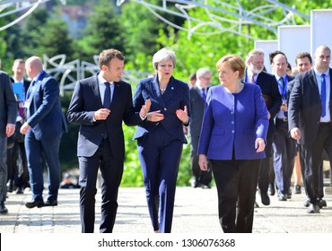  Sofia, Bulgaria - May 17, 2018 : French President Emmanuel Macron, British Prime Minister Theresa May and German Chancellor Angela Merkel walk during the EU-Western Balkans Summit in Sofia.