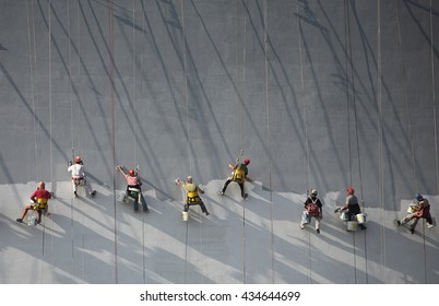 SOFIA, BULGARIA - SEPTEMBER 08 2008. Team Of Builders Painting A Wide Wall Of A New Building.