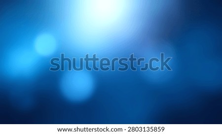 A soft abstract background featuring blue bokeh light circles and a bright glowing flare at the top